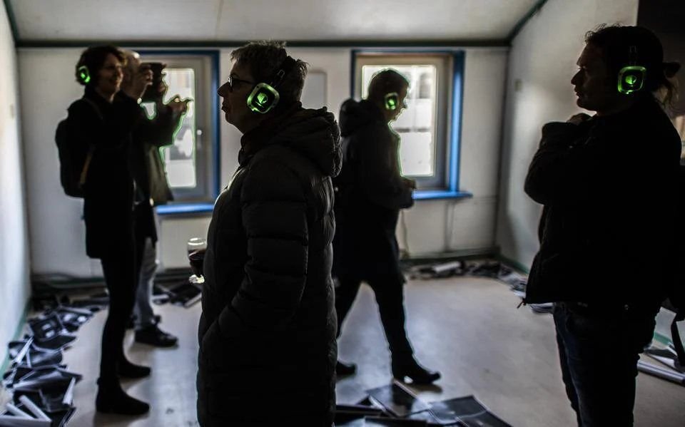 Visitors wearing headphones in the home at Meerweg 6
