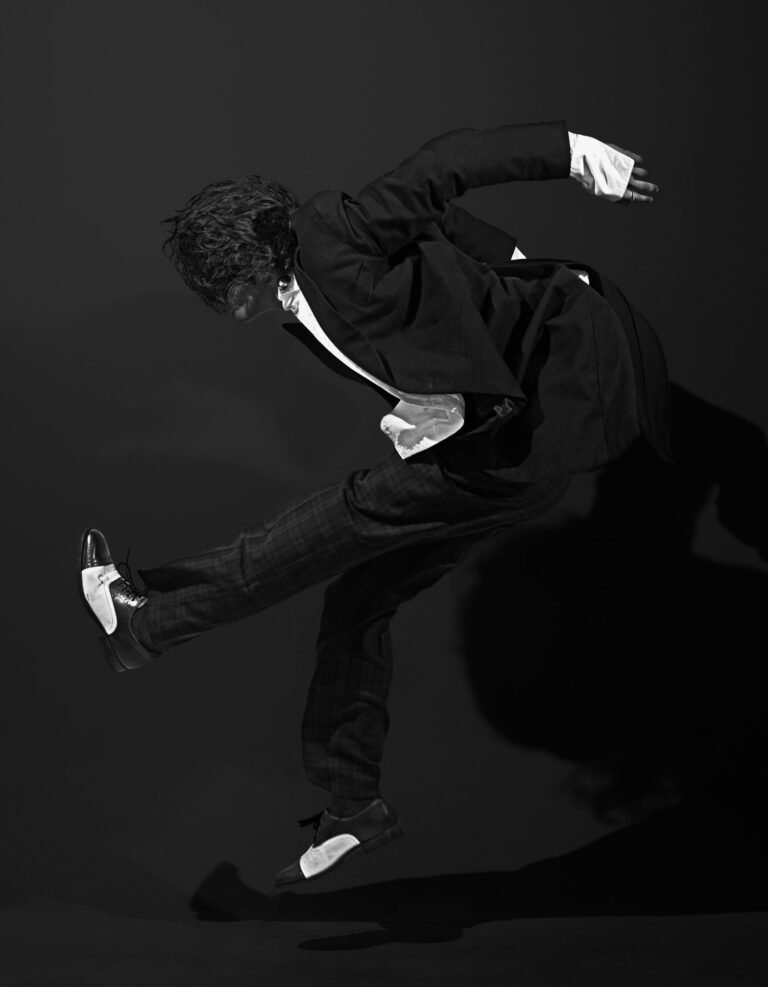 Monochrome dancer suspended in an angular gesture